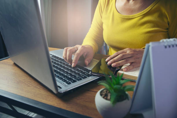 istock Hands Woman using laptop, work from home concept. Financial advisor planning on Remote working online and business meeting at Home office, watching webinars and talking during meeting video conference 1330010918