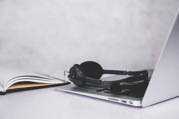 istock Laptop computer and headphone on desk, e-learning online, webinar for education and learning, seminar with notebook, video conference, headset for multimedia, course and classroom to internet. 1330010927