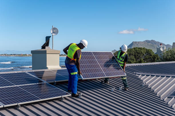 Installing solar panels on a residential building stock photo