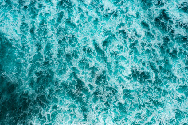 istock Texture Light blue surface of raging sea water with white foam and wave pattern 1330011726