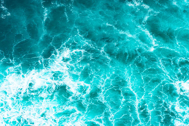 istock Texture Light blue surface of raging sea water with white foam and wave pattern 1330011765