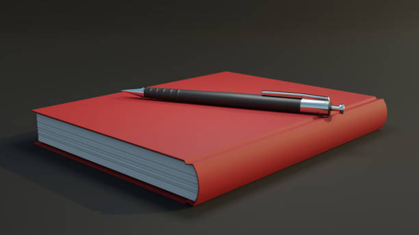 Red thick hardcover notebook with a ball pen placed on it.