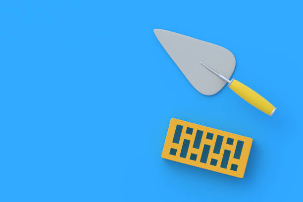 istock Perforated clay brick near trowel on blue background. Home repairs. Construction materials. Developer services. Top view. Copy space. 3d render 1330012281