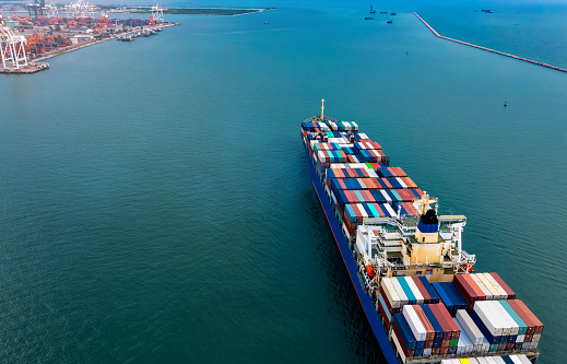 The  business of the logistic container ship for import-export of International Container Cargo ship  while in the ocean, Freight Transportation, Shipping concept