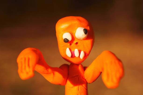 Orange zombie figurine close-up.