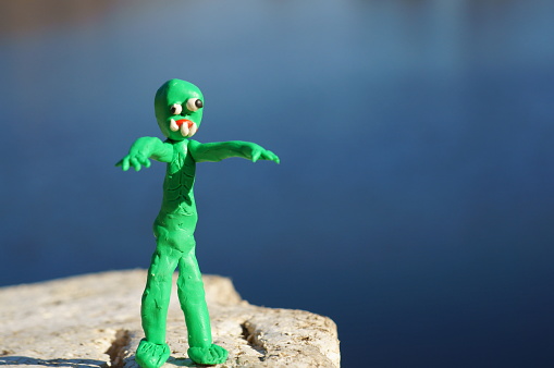 A zombie figurine made of plasticine. An object made with your own hands.