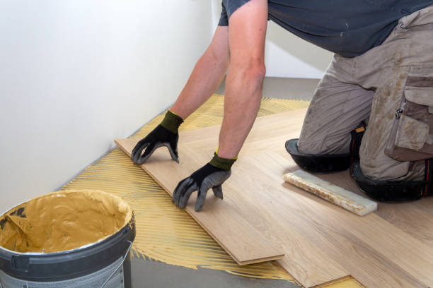 istock Craftsman laying herringbone parquet flooring professionally 1330013799