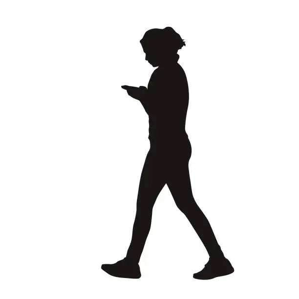 Vector illustration of Young woman walking with mobile phone in her hands, isolated vector silhouette, side view