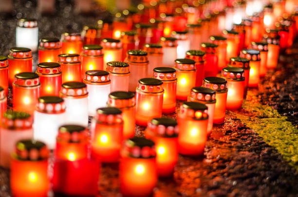 istock Lots of burning candles arranged in rows on the pavement 1330014895