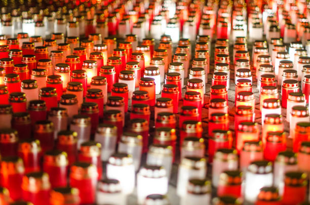 istock Lots of burning candles arranged in rows on the pavement 1330014958