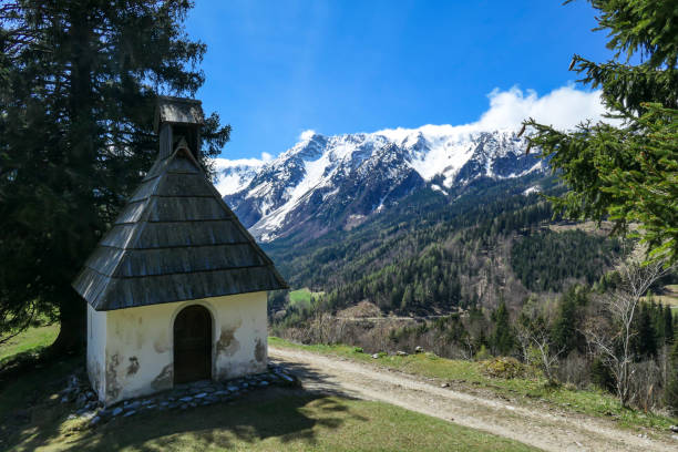 istock Matschacher Gupf - A small chapel with a panoramic view on Baeren Valley in Austrian Alps. The highest peaks in the chain are snow-capped 1330015785