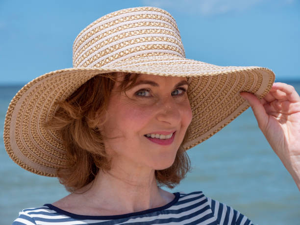 istock Mature woman with beach hat 1330017268