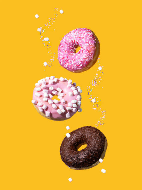 Donuts with sprinkles on a yellow background