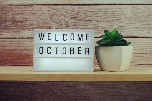 istock Welcome October word in light box on wooden shelves background 1330018576
