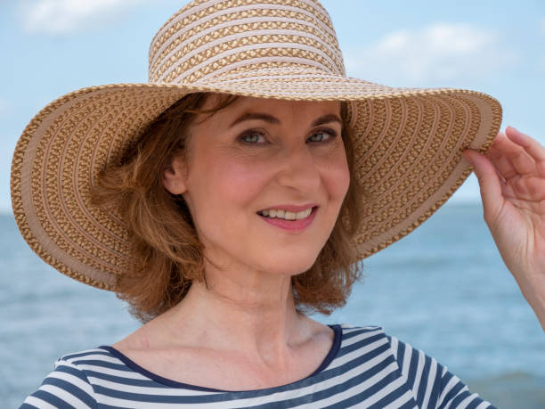 istock Mature woman with beach hat 1330019715