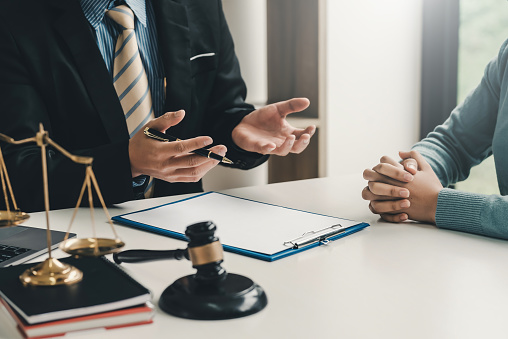 Image lawyer businessman sitting at the office with a woman customer explaining the agreement of advice.