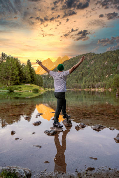 istock Traveler Man Hiker looking sun over horizon 1330021288
