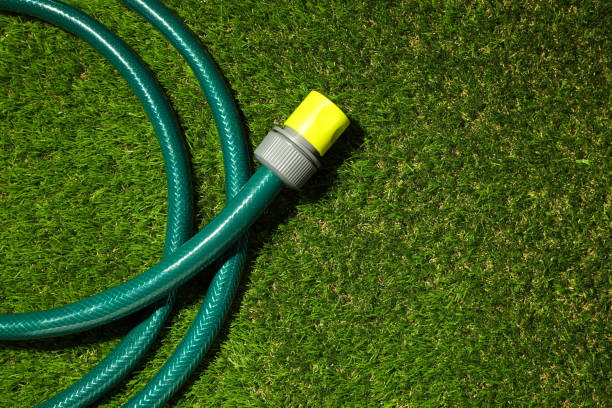 istock Watering hose on green grass, top view. Space for text 1330021395