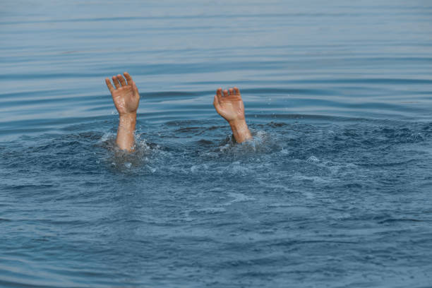 istock Drowning man reaching for help in sea, closeup 1330021462