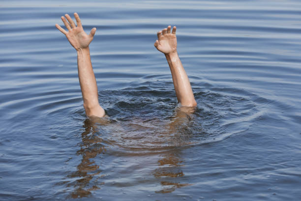 istock Drowning man reaching for help in sea, closeup 1330021486