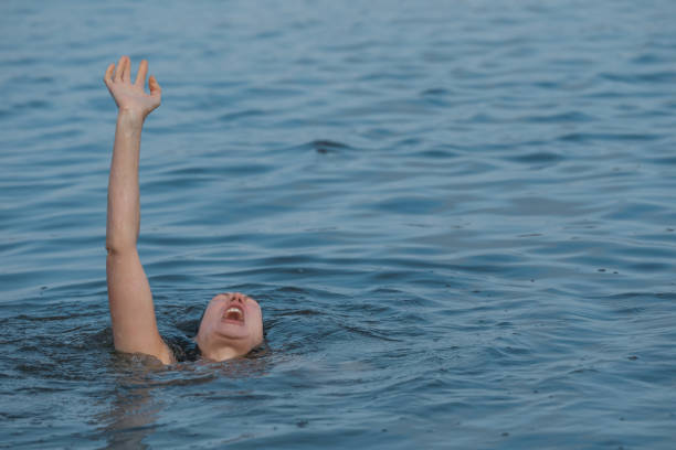 istock Drowning woman reaching for help in sea 1330021488