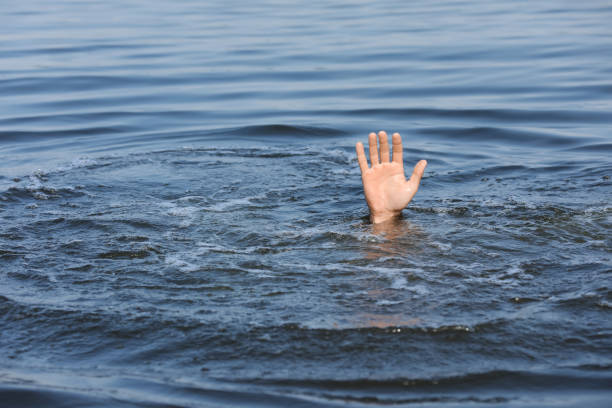 istock Drowning man reaching for help in sea, closeup 1330021537