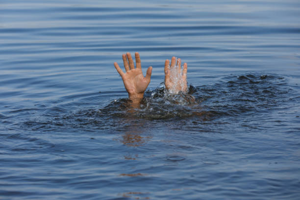 istock Drowning man reaching for help in sea, closeup 1330021863