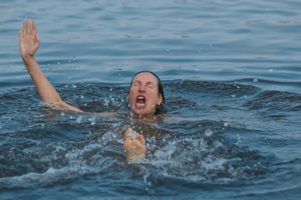 istock Drowning woman reaching for help in sea 1330021996