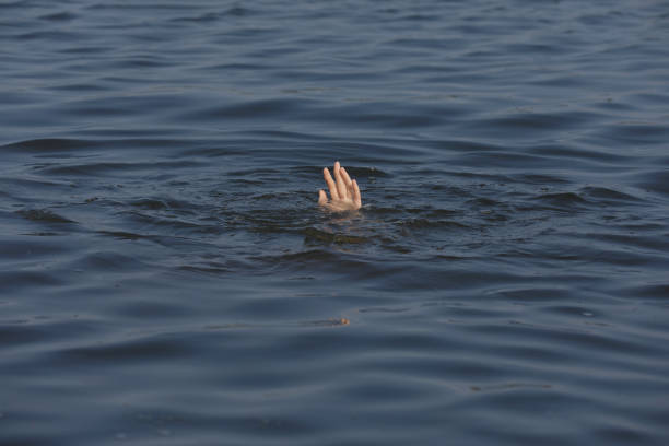 istock Drowning woman reaching for help in sea, closeup 1330022026