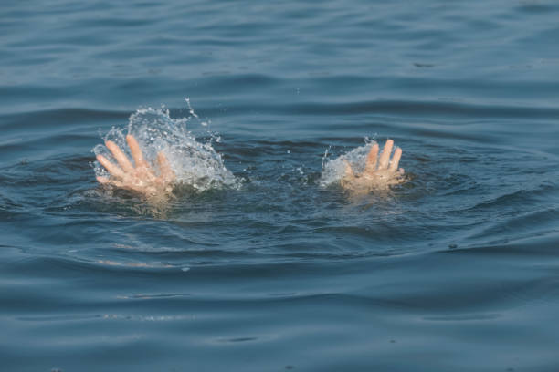 istock Drowning woman reaching for help in sea, closeup 1330022028