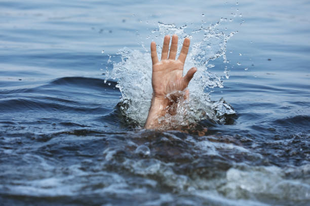 istock Drowning man reaching for help in sea, closeup 1330022090