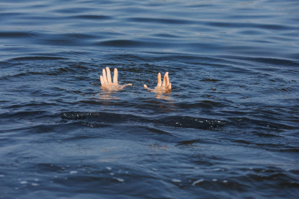 istock Drowning woman reaching for help in sea, closeup 1330022113