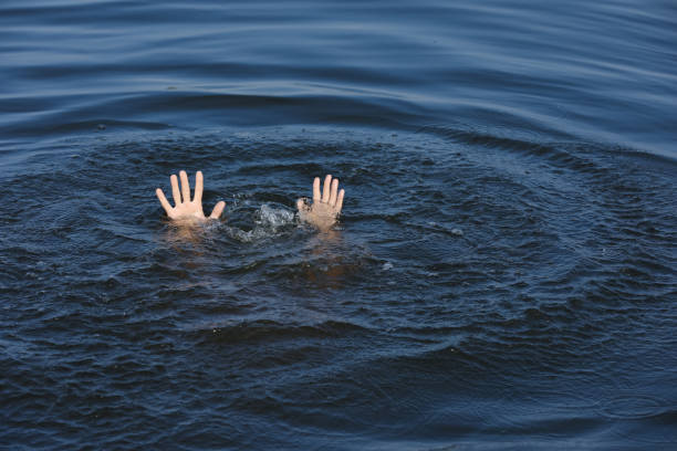 istock Drowning man reaching for help in sea, closeup 1330022723