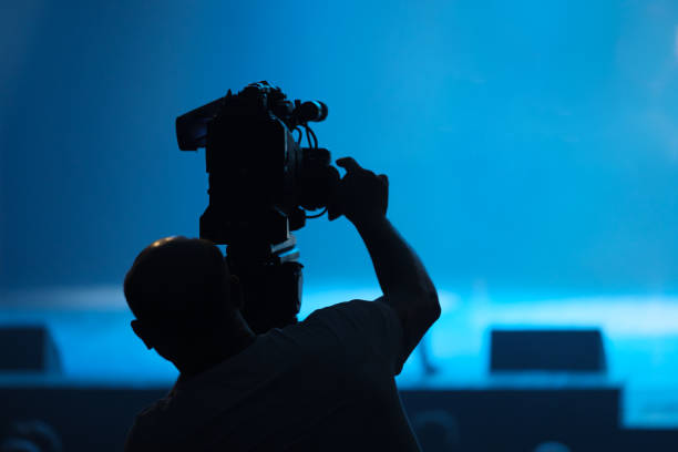 istock A cameraman with a video camera is filming. 1330023003