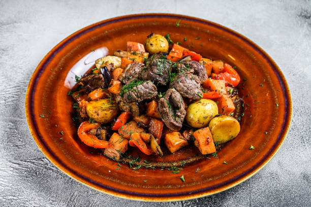 istock Meat stew, goulash on a plate. White background. Top view 1330023088
