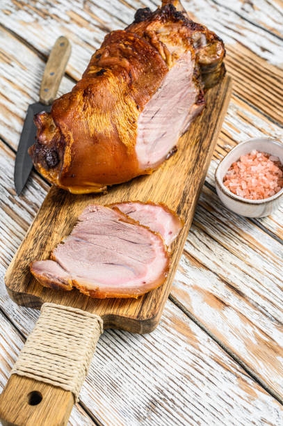 istock Sliced roasted pork knuckle on a cutting board. wooden background. Top view 1330024480