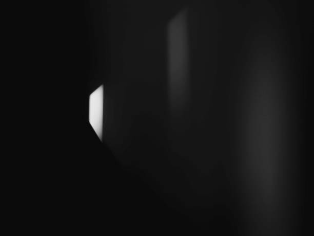 istock Shadow of light, black and white abstract backdrop. Darkroom with light beams. Background for mystery, hope, and conceptual design with space for text. 1330026877