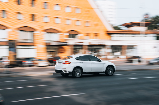 Ukraine, Kyiv - 16 July 2021: White BMW X6 car moving on the street. Editorial