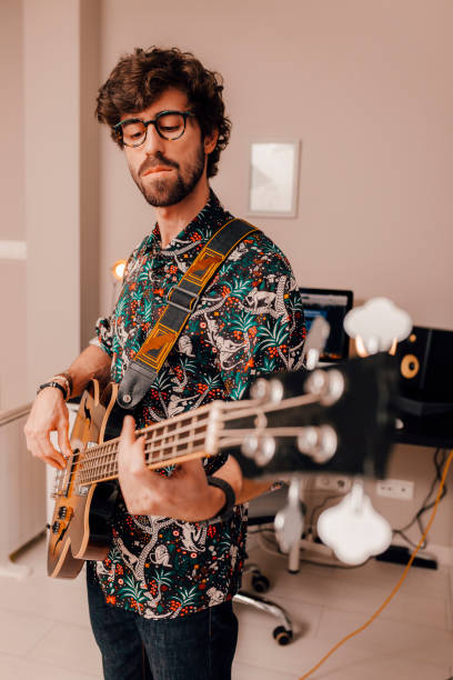 istock Musician plays bass guitar 1330027690