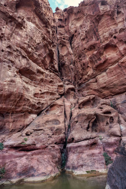istock Tall red rocky wall with water on ground - Wadi Rum scenery 1330028463
