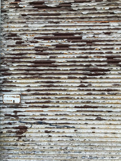 rust on the old corrugated white fence. Balchik. Bulgaria.