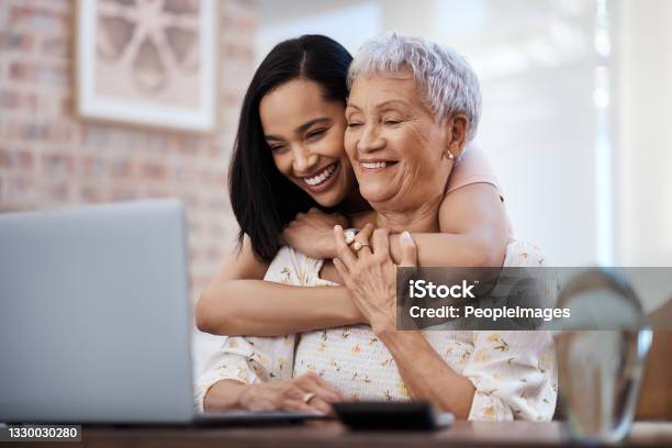 Shot Of A Senior Woman Using A Laptop With Her Daughter At Home Stock Photo - Download Image Now