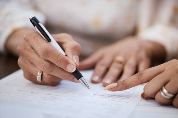 Shot of a woman going over paperwork with her elderly mother at home A retirement plan you can bet your life on banking document stock pictures, royalty-free photos & images