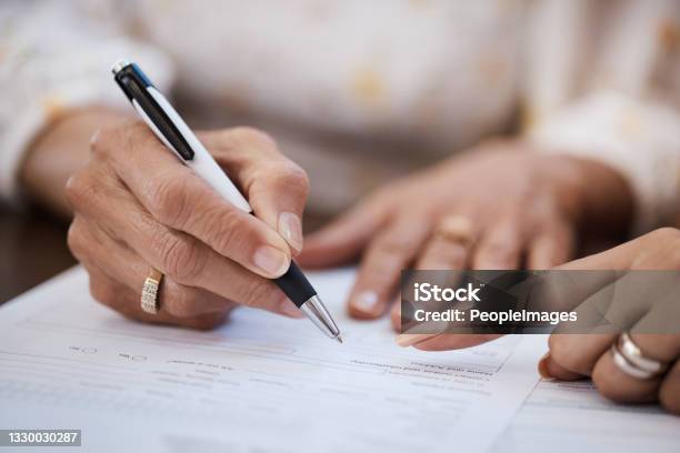 Shot Of A Woman Going Over Paperwork With Her Elderly Mother At Home Stock Photo - Download Image Now