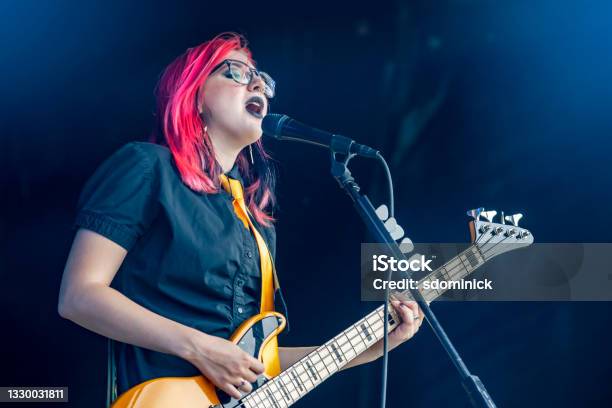 Female Bassist And Signer Performing Live Stock Photo - Download Image Now - Popular Music Concert, Teenager, Musician