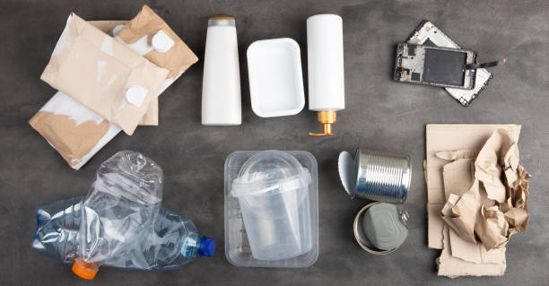 istock Recycling and ecology concept. Sorting household waste - plastic, paper, metal and electronics, captured from above, flat lay. Grey concrete background 1330031903