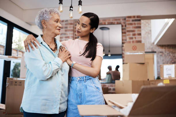 Shot of a senior woman moving house with help from her daughter I'll visit you every weekend, Mom unpacking photos stock pictures, royalty-free photos & images