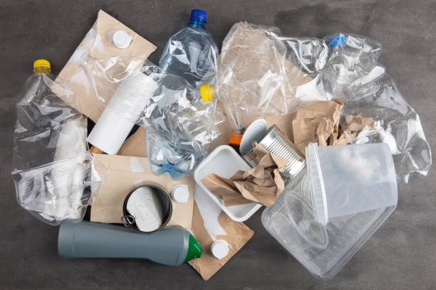 istock Recycling and ecology concept. Sorting household waste captured from above, flat lay. Grey concrete background 1330032481