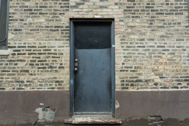 istock Vintage brick building with black door in urban setting 1330033718