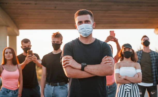 istock Guy at the front of crowd. Group of protesting young people that standing together. Activist for human rights or against government 1330034793